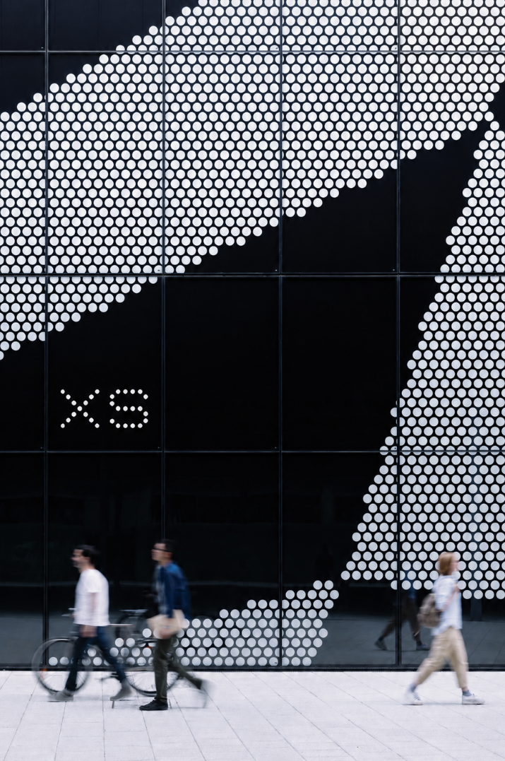 XS dot-matrix facade signage with passers-by