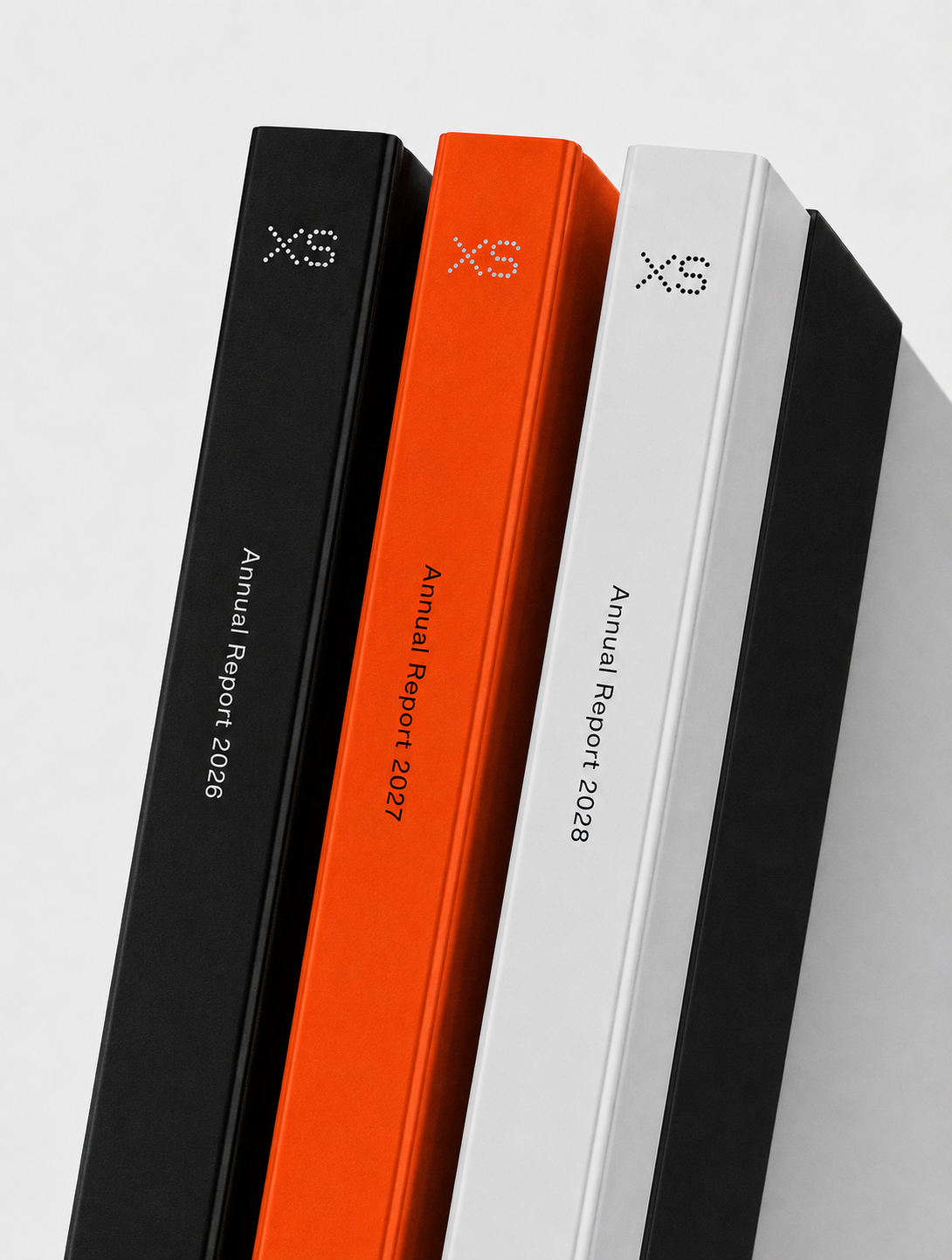 XS annual report spines in ink, signal and paper
